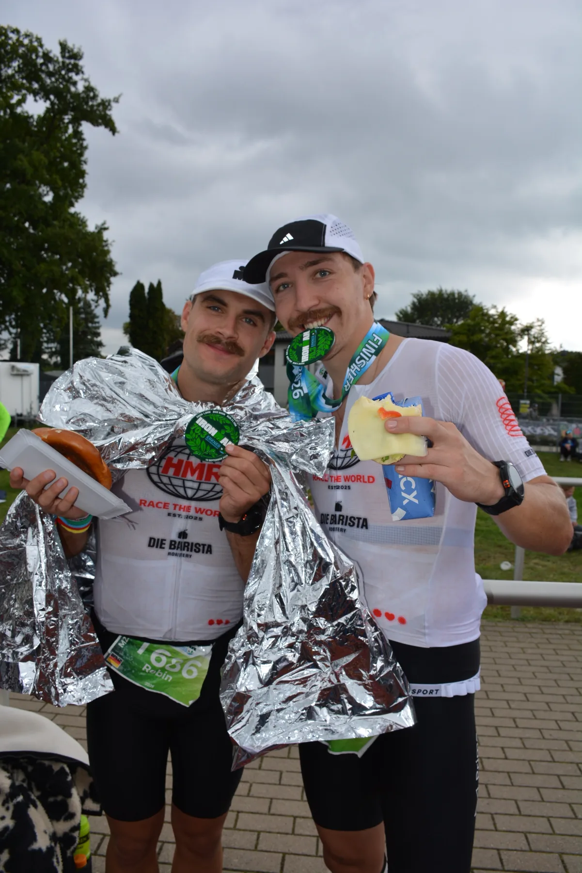 Two HMR finishers in their custom suits with their medals